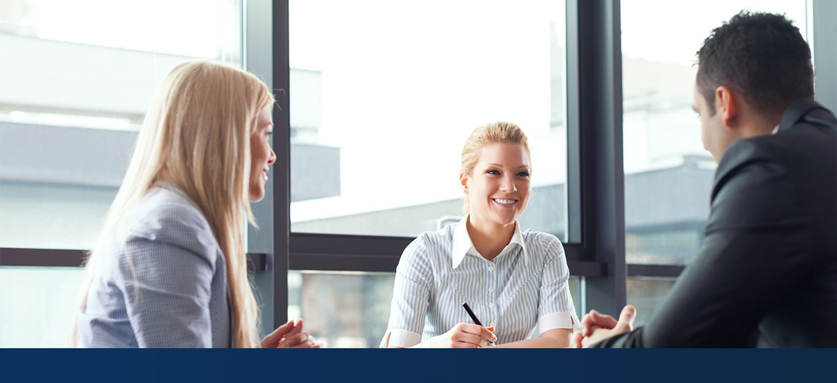 group of smiling professionals in a meeting