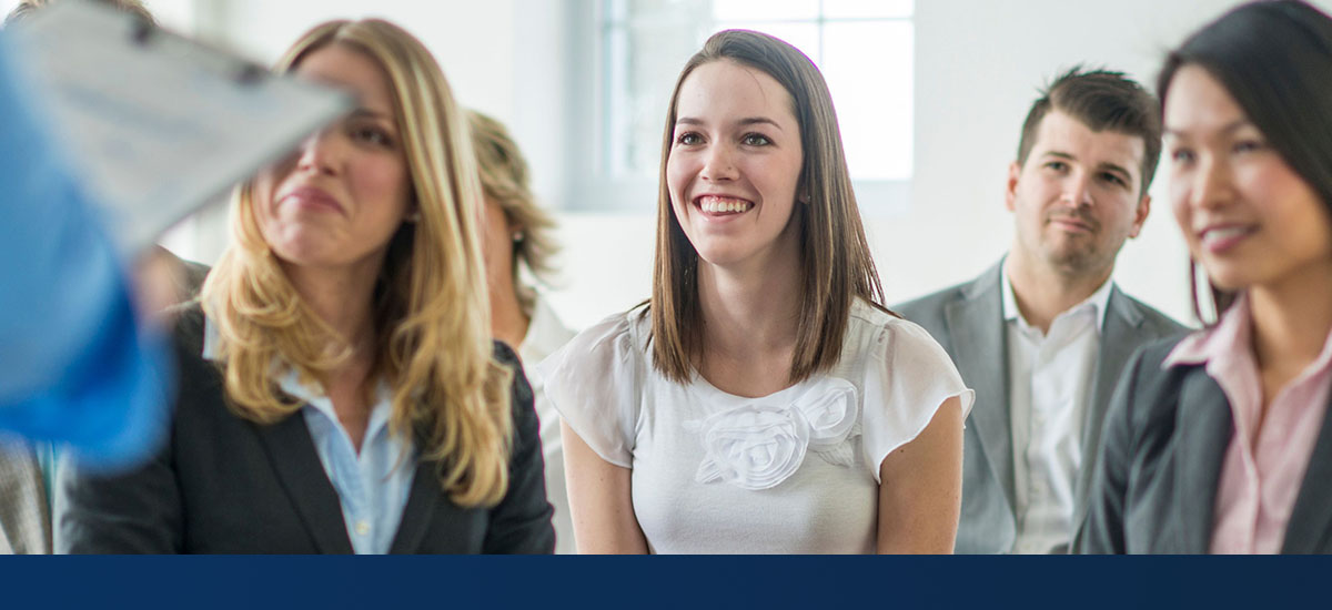 group of happy people watching a presentation